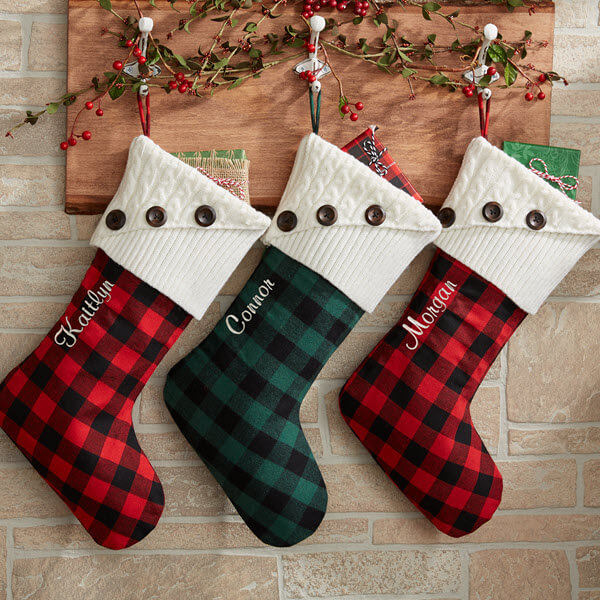 Personalized plaid decor with personalized stockings hanging on the wall.
