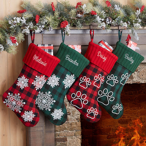 Personalized plaid decor with personalized stockings hanging on the wall.