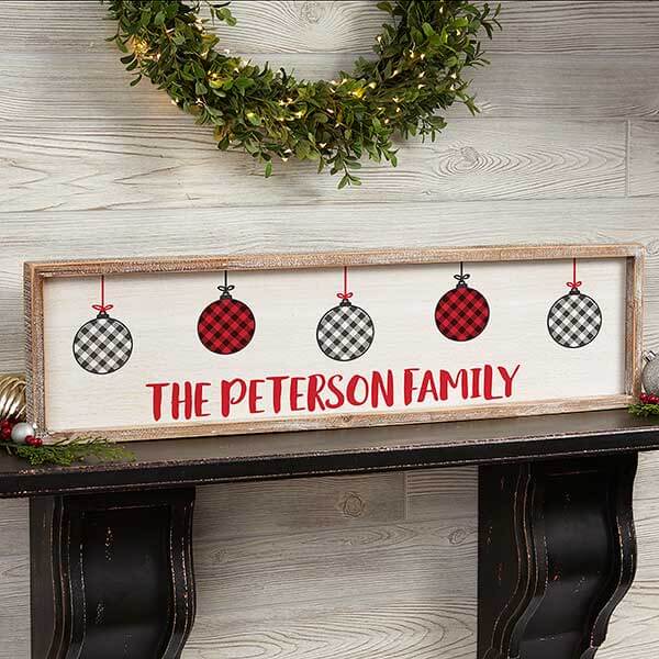 Personalized plaid decor with a framed art piece on top of a mantel.