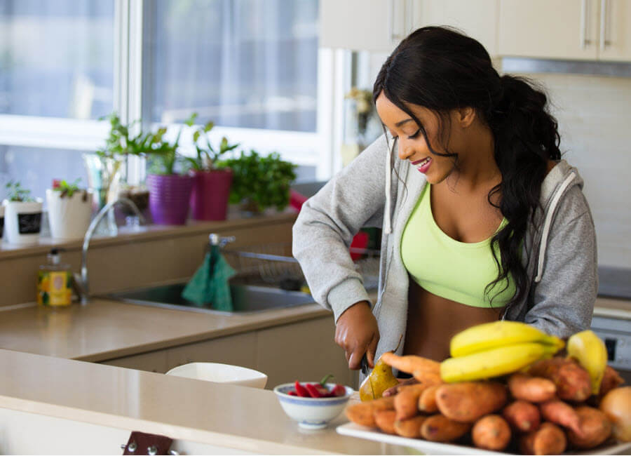 New Year's Resolutions woman cutting fruit