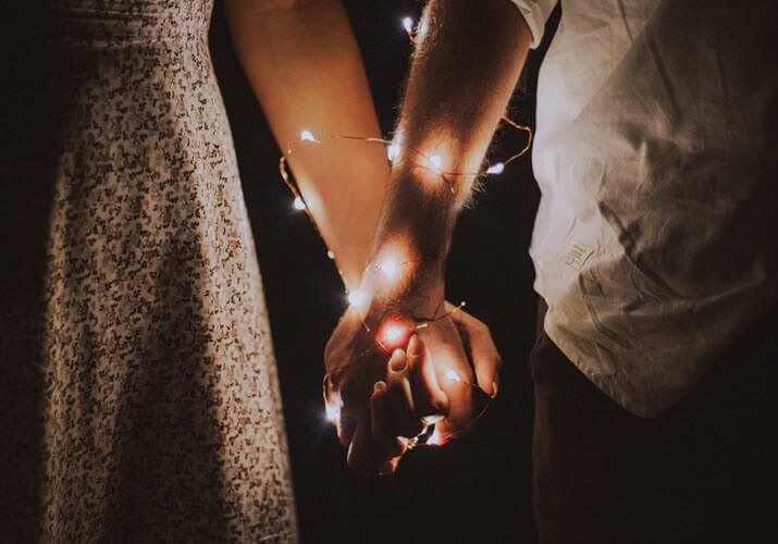 first christmas keepsakes with couple holding hands on first christmas together