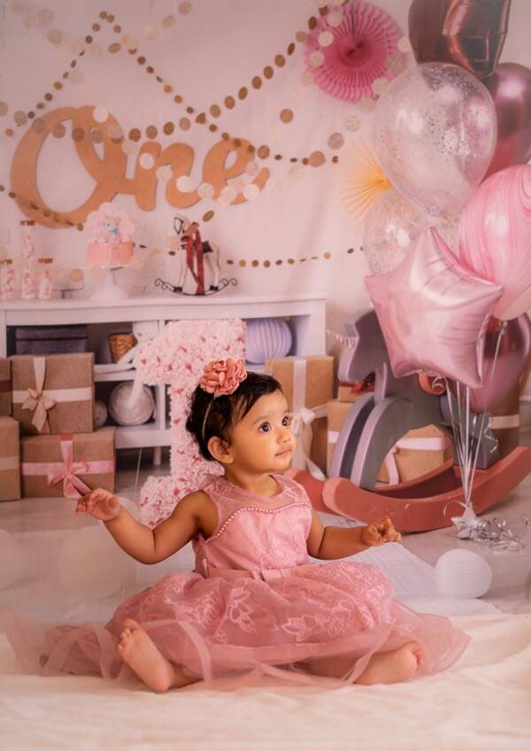 first birthday gift ideas with little girl dressed like ballerina sitting on floor in room