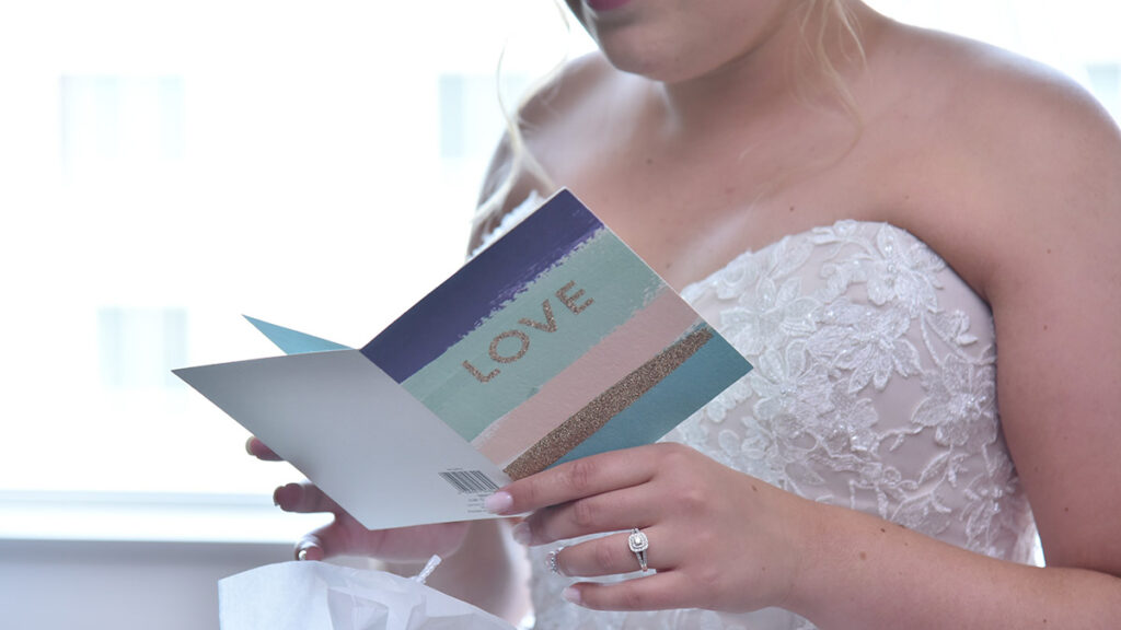 The bride is reading a gift card.
