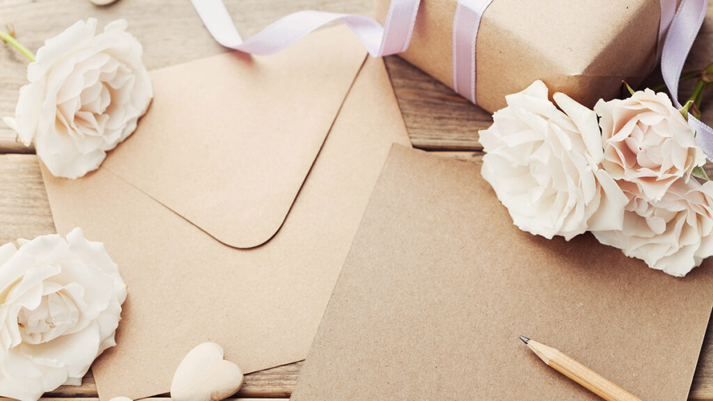 Envelope or letter, gift, paper card and vintage rose flowers on