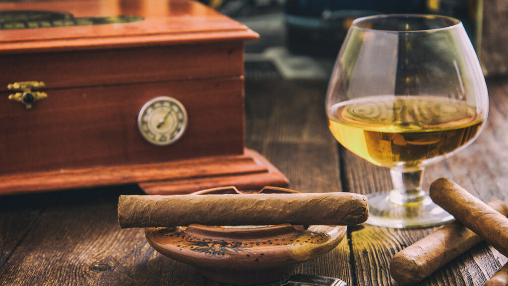 cigar and cognac with humidor in background