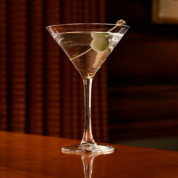 Close up shot of a martini glass on a bar table