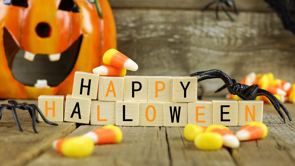 Happy Halloween wooden blocks with candy corn and decor against